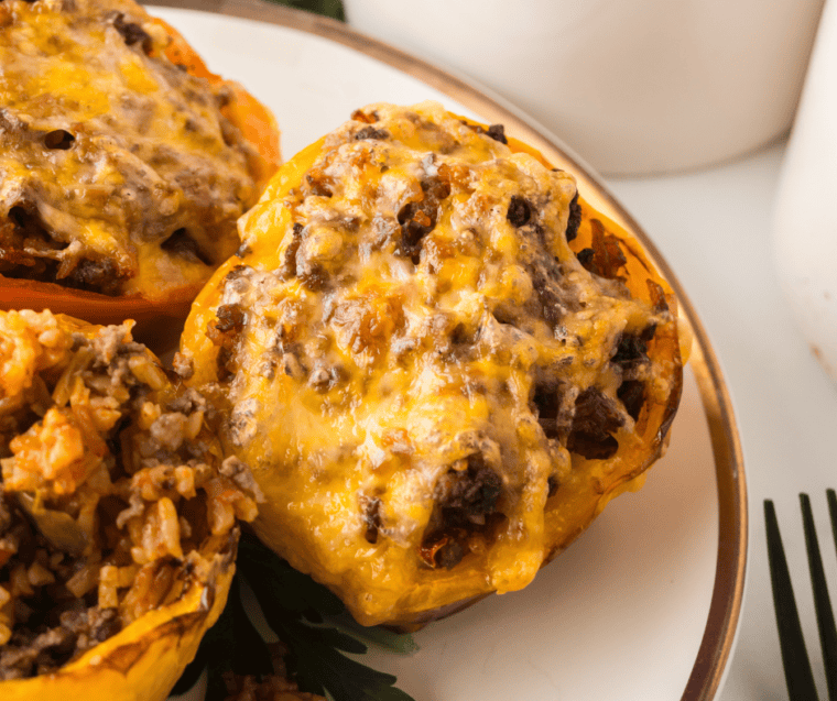 Ninja Crispi stuffed peppers with melted Colby Jack cheese in the glass air fryer container, ready to serve