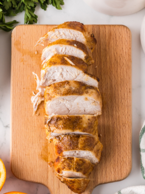 Sliced Ninja Crispi turkey breast with golden crispy skin on a wooden cutting board