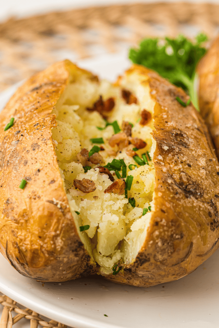 Loaded Ninja Crispi baked potato topped with cheddar, bacon, sour cream, and chives