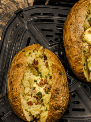 Ninja Crispi baked potato split open with crispy skin and melting butter
