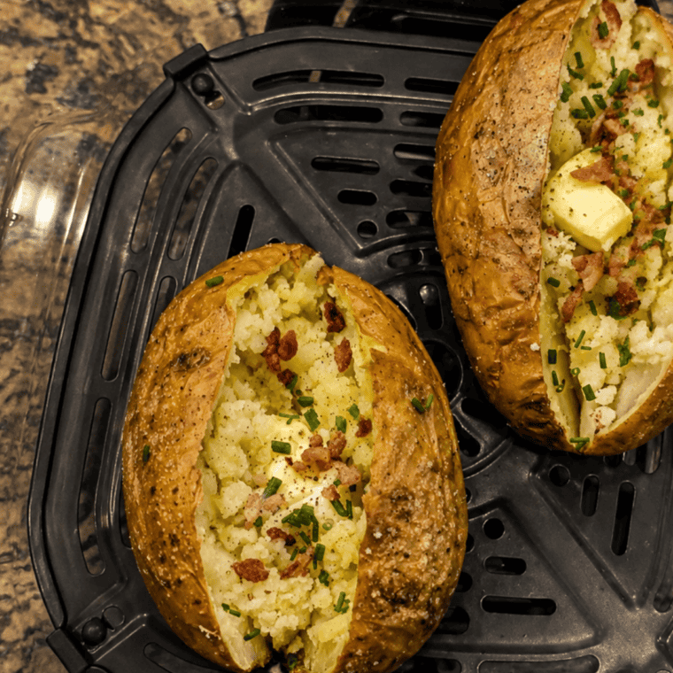 Ninja Crispi baked potato split open with crispy skin and melting butter