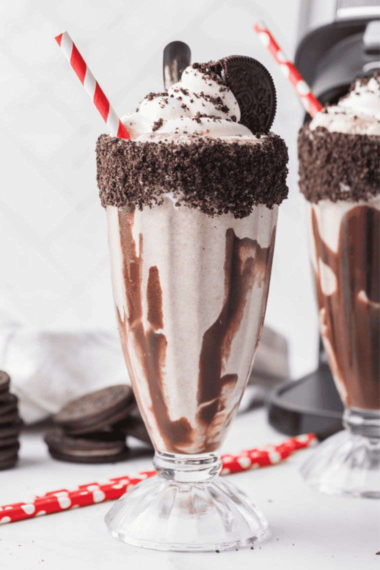 Two Ninja Slushi Oreo milkshakes topped with whipped cream, crushed cookies, and a whole Oreo