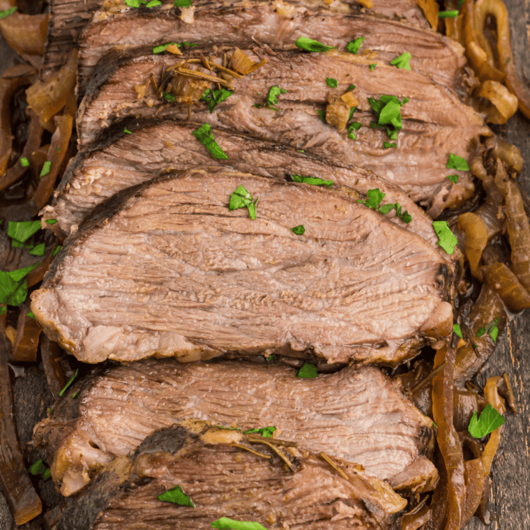 Fork-tender slow cooker tri tip sliced against the grain, drizzled with onion gravy