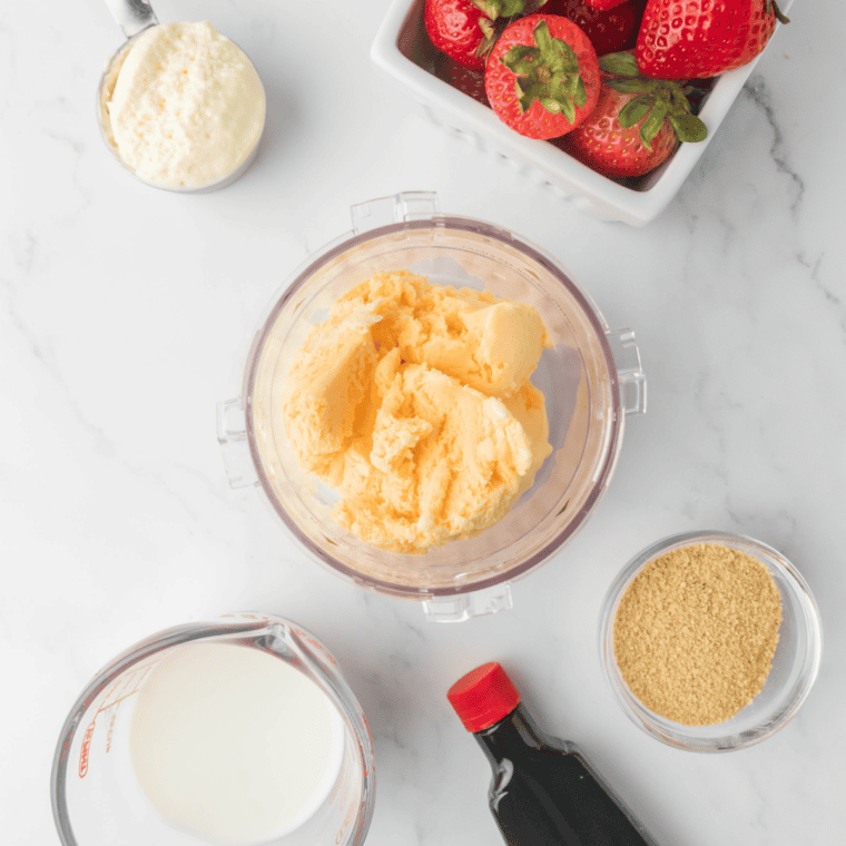 Ingredients for a Ninja Slushi strawberry milkshake — strawberries, milk, heavy cream, sugar, vanilla